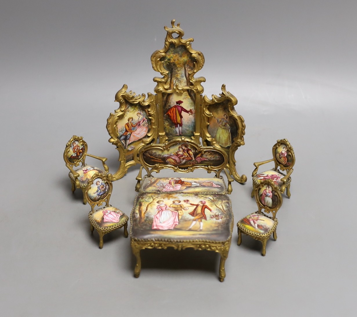 A suite of Viennese enamelled miniature furniture: 3 fold screen, table, salon sofa, a pair of armchairs and 2 dining chairs